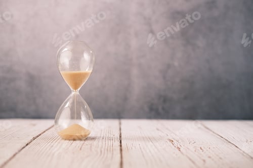 Preview: hourglass on table, sand flowing through the bulb of sandglass