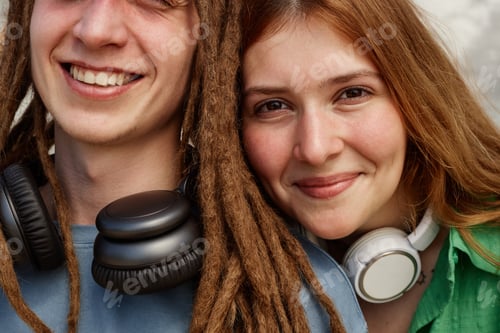 Preview: Smiling Young Adults Wearing Headphones Smiling Together
