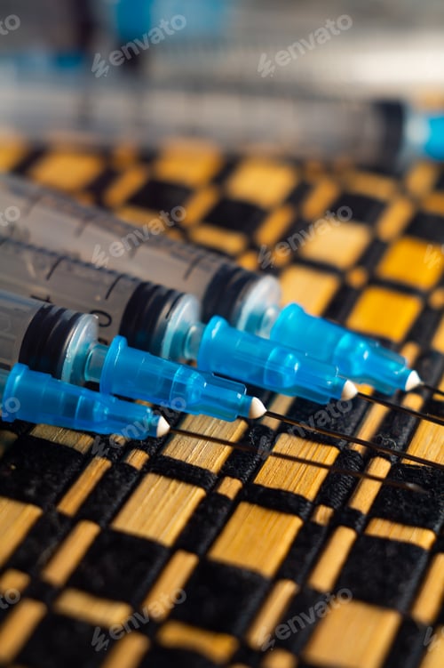 Preview: Close-up photo of a set of syringes on a wooden surface