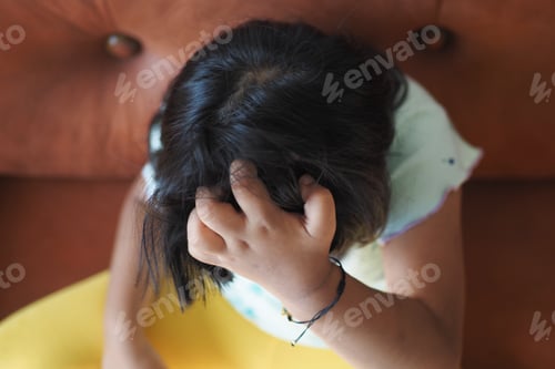 Preview: A child in contemplation, hand on head, in a colorful, serene setting