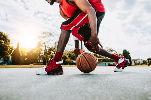 Preview: Basketball street player dribbling with ball on the court