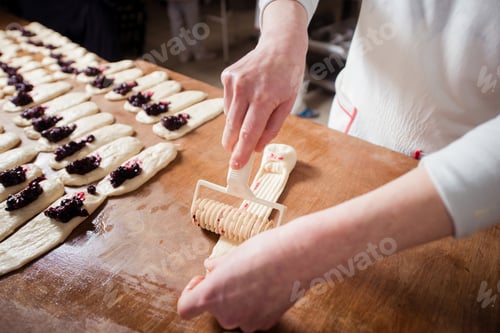 Preview: Woman baker make buns with fruit filling from dough