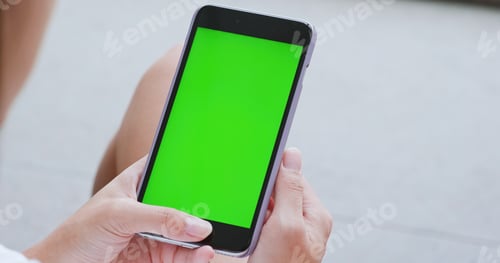 Preview: Woman use of smart phone with green screen, chroma key