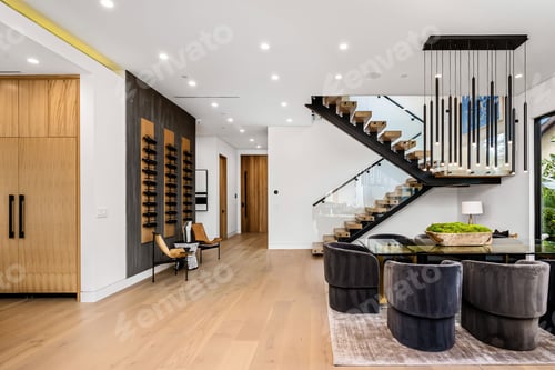 Preview: Modern open-concept living and dining area with stylish staircase.