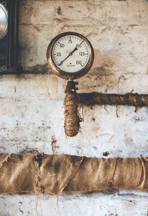 Preview: Vertical view of the vintage team engine pressure gauge and lagged pipes
