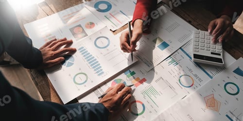 Preview: Business People Meeting using laptop computer,calculator,notebook,stock market chart paper for