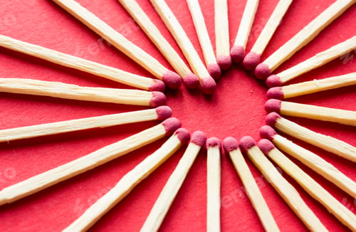 Preview: Red matches in the shape of a heart on the dark black background. Symbol of love