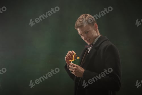 Preview: Young man in art action isolated on dark green background. Retro style, comparison of eras concept