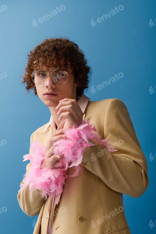 Preview: Teenager showcases vibrant fashion style with playful accessories against a blue backdrop