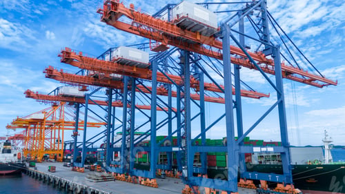Preview: crane loading cargo container from truck to container ship in the international