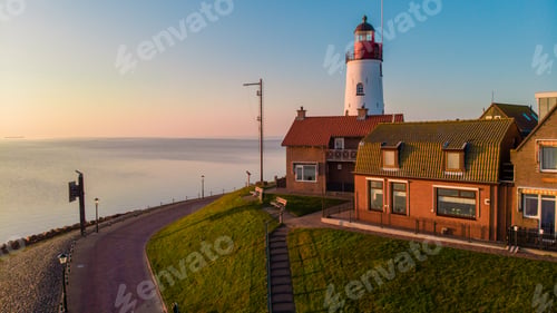 Preview: Urk Flevoland Netherlands sunset at the lighthouse and harbor of Urk Holland. Fishing village Urk