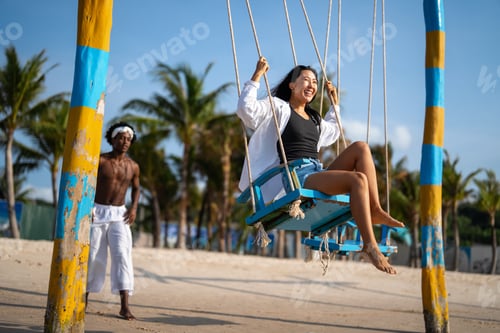 Preview: Interracial couple enjoying the freedom of summer, laughing and playing on a tropical beach