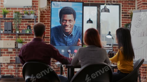 Preview: Group of workmates attending video call meeting with man