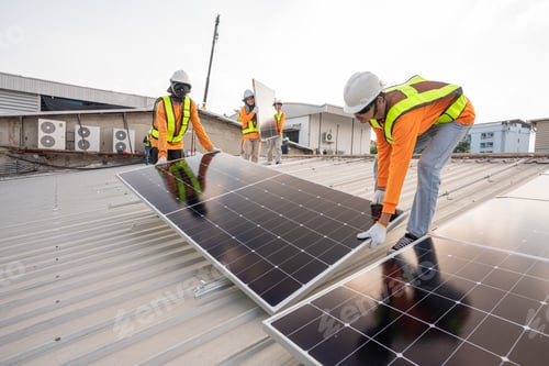 Preview: Team technicians carrying photovoltaic solar moduls on roof.