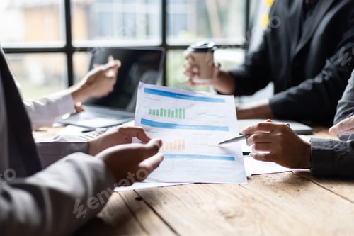 Preview: Professionals Reviewing Graphs at Conference Table