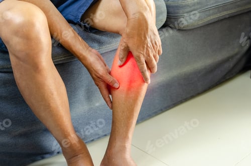 Preview: Injury or knee pain of an elderly man on the sofa.