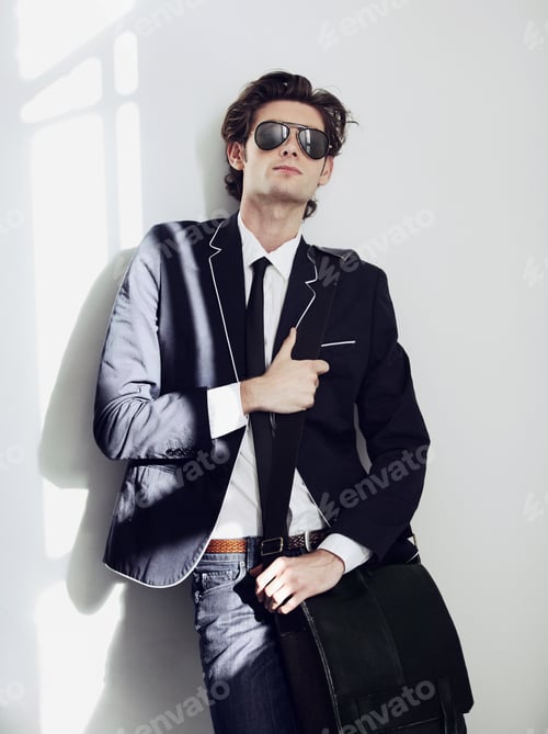 Preview: The personification of cool. A young man, well-dressed, posing for the camera.