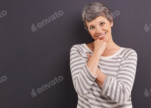 Preview: Smiling Woman with Hand on Chin on Gray