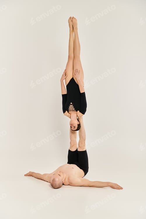 Preview: Man Holds a Woman by his Legs while she is Upside Down