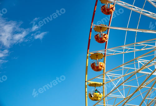 Preview: Multicolour ferris wheel isolated on blue sky background, Having fun on an amusement fairground park