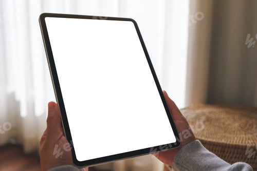 Preview: Mockup image of a woman holding digital tablet with blank desktop screen at home