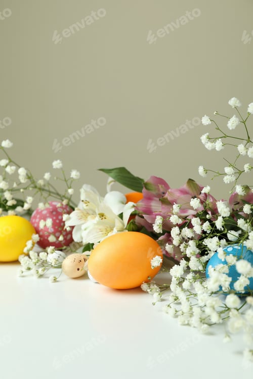 Preview: Easter eggs and beautiful flowers on white table