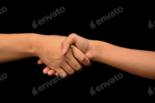 Preview: Man and woman shaking hands isolated on black background.