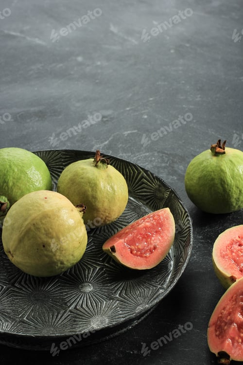 Preview: Fresh Sliced Guava (Jambu Biji Merah) or Psidium Guajava. Served on Rustic Plate