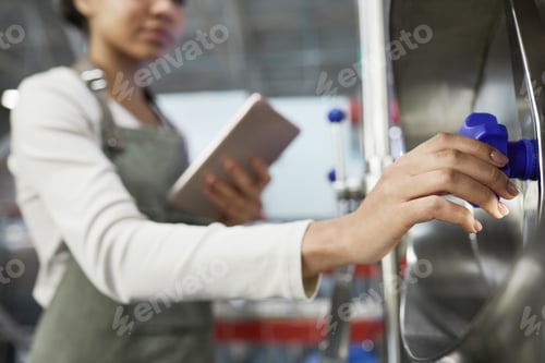 Preview: Female Worker Opening Valve at Factory Close Up