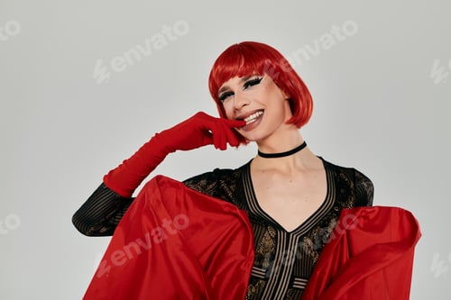 Preview: Vibrant Young Drag Queen Radiating Confidence in Bold Red Attire