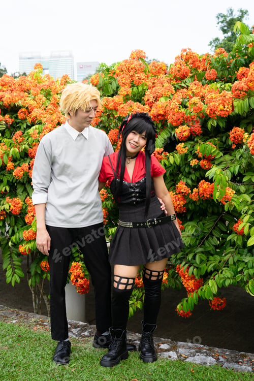 Preview: Cosplayers posing together in front of orange flowers