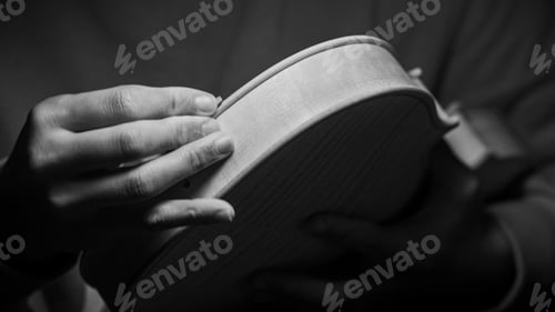 Preview: violin maker luthier hands roughing the edges of a raw blank violin with sandpaper