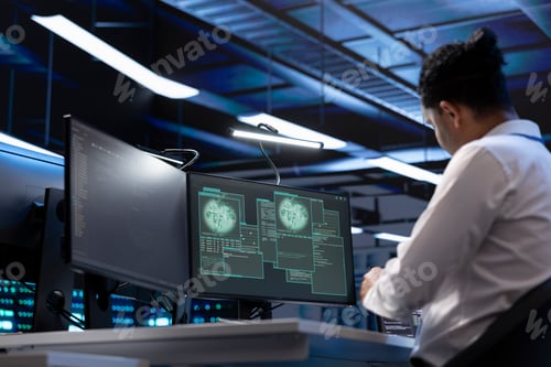 Preview: Software developer using computer in server room to support global connections