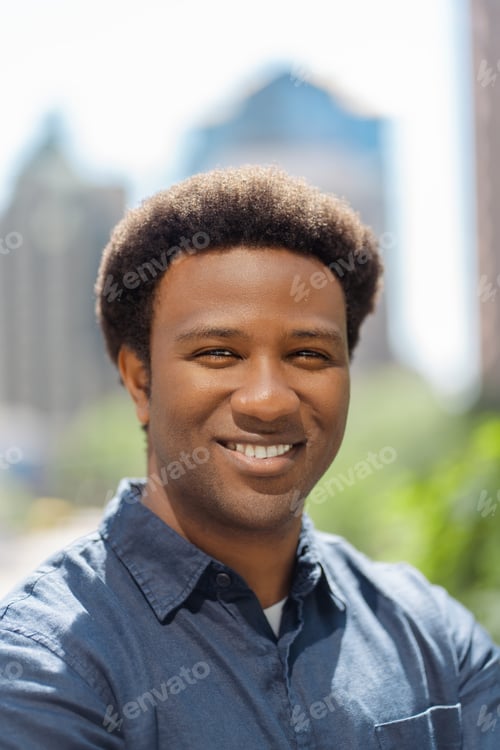 Preview: Closeup portrait of smiling businessman, сeo, standing looking at camera, on urban street