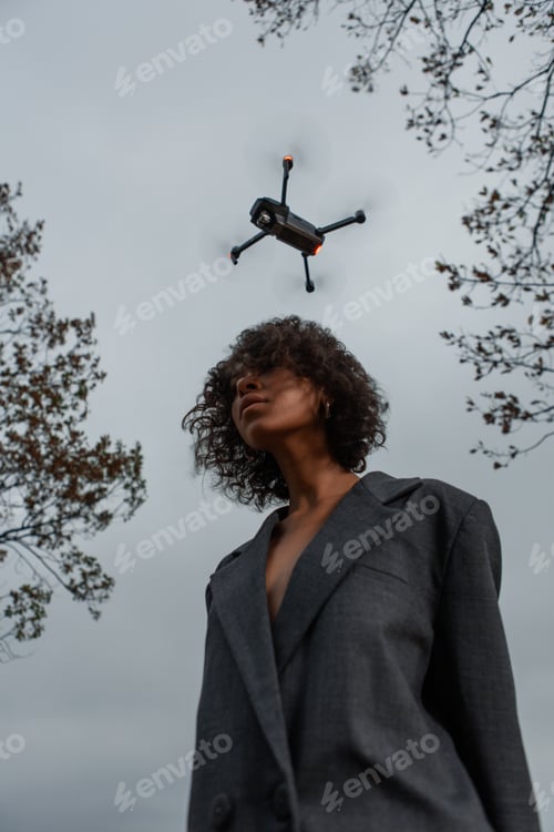 Preview: Beautiful Girl With Curly Hair In A Stylish Suit Walks Against The Backdrop Of A Beautiful Landscape