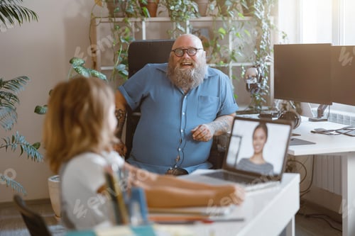 Preview: Joyful father looks at little girl studying distantly with laptop in light room