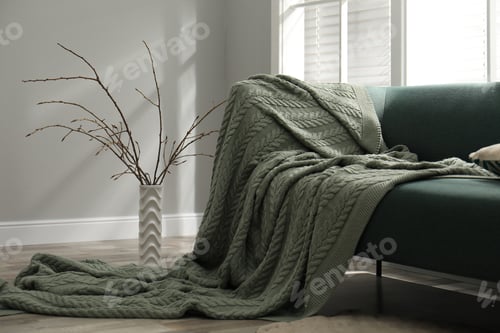 Preview: Beautiful tree twigs in vase on floor near sofa indoors
