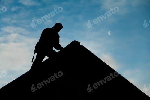 Preview: Contractor in Silhouette working on a Roof Top