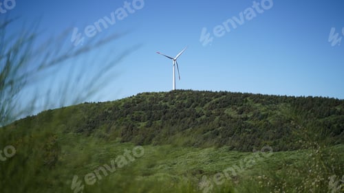 Preview: Wind turbine on a top of a green hill