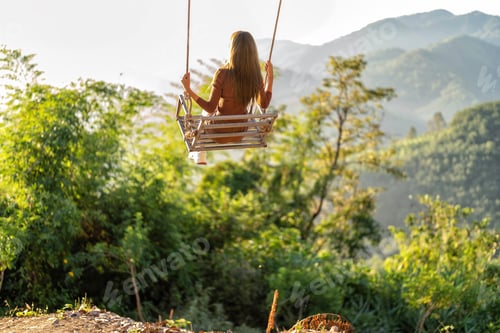Preview: Sunshine morning traveler girl sit swinging hang from tree swing on greenery forest the mountain