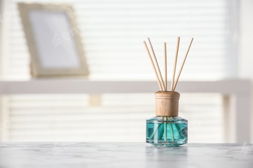 Preview: Aromatic reed air freshener on white table at home, space for text