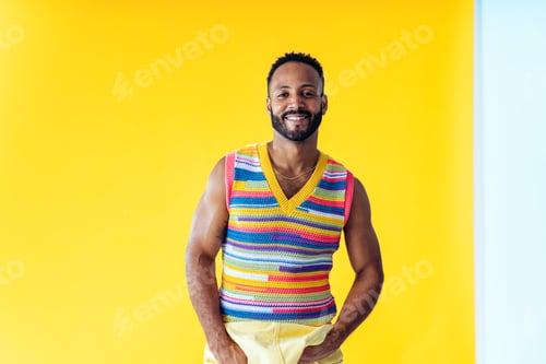 Preview: Man posing on colored backgrounds in studio wearing trendy clothes