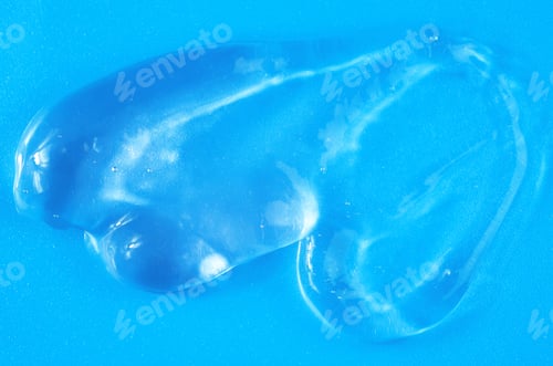 Preview: A smear of transparent gel on a blue background. Cosmetic. Skin care, hair care, nail care.