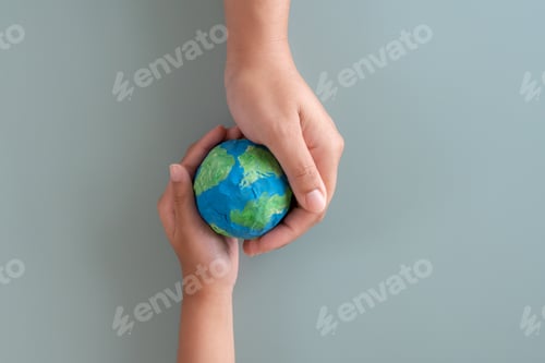 Preview: Hands holding earth paper and water paint. Concept of sustainability environment protection