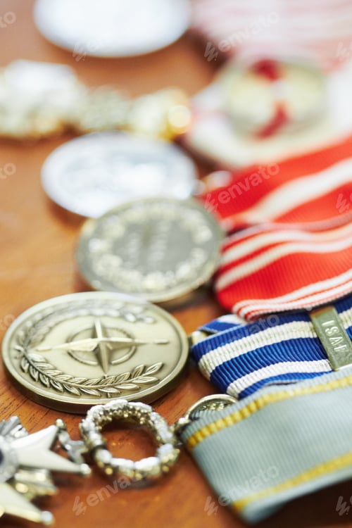 Preview: To honor and serve. Closeup shot of war medals lying on a table.