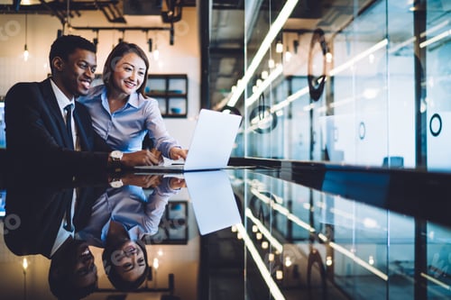 Preview: Multiracial colleagues watching video on laptop