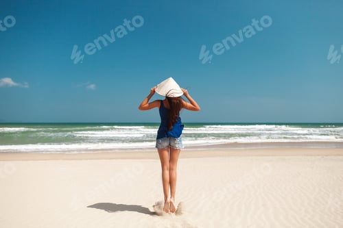 Preview: Woman in Hat Walking on a Tropical Beach