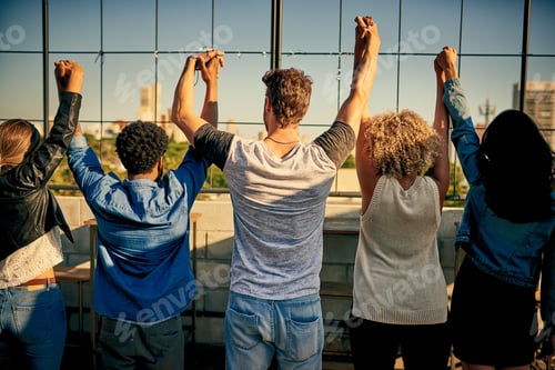 Preview: Rearview shot of unrecognizable friends spending the day outside on a rooftop