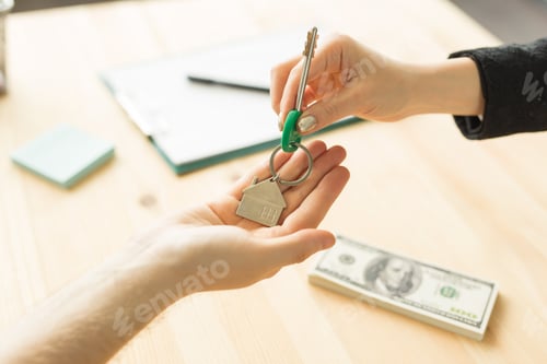 Preview: Business, realtor and real estate concept - Hand-to-hand key from new home