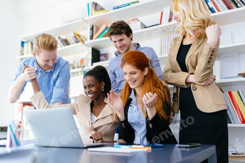 Preview: Happy business coworkers celebrating